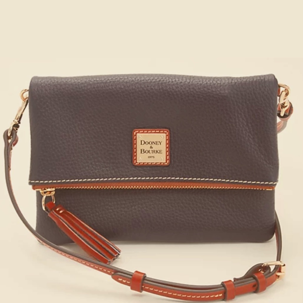Dooney & Bourke foldover crossbody made of  smooth pebble leather.